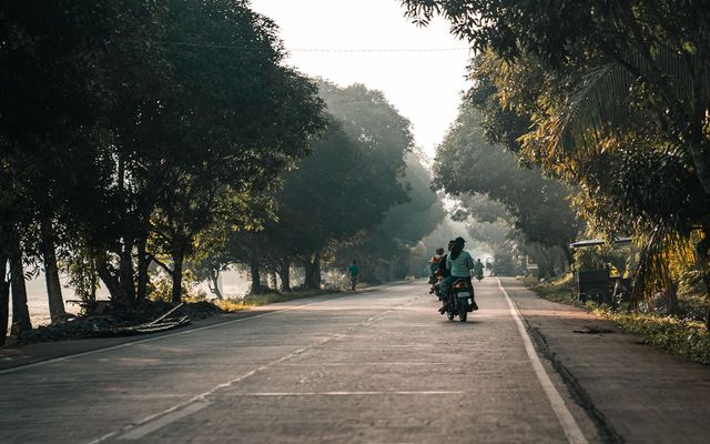 person riding motorcycle on road