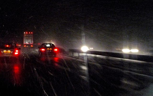 Cars driving on a wet road at night