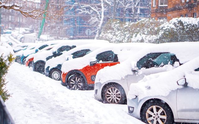 black suv covered with snow