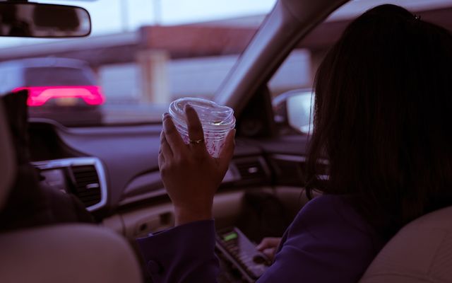 Driver using a phone while driving, illustrating distracted driving dangers
