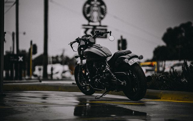 A parked motorcycle on a wet street