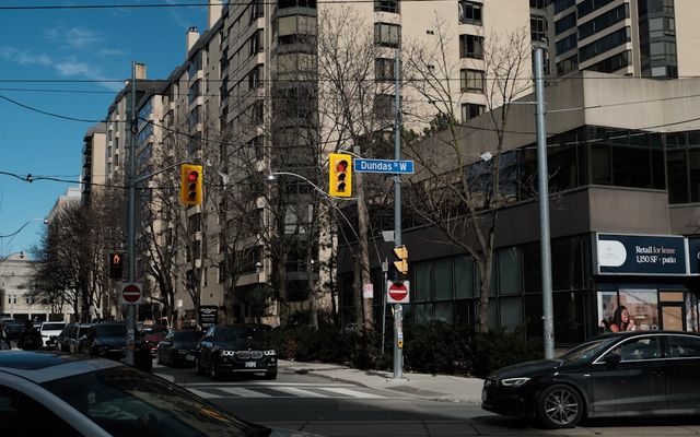 City street with apartment buildings and cars.