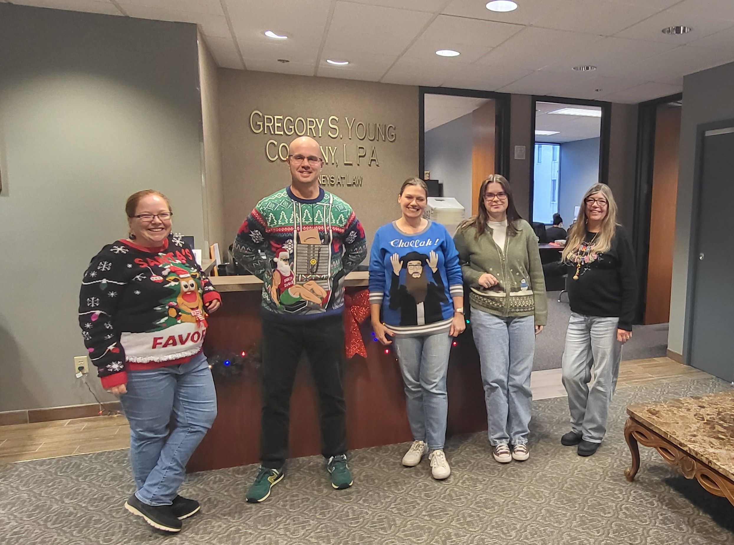 Gregory S. Young Co., LPA team in ugly sweaters at the 2025 office holiday party
