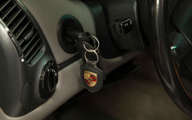 A car door handle with a car key on it