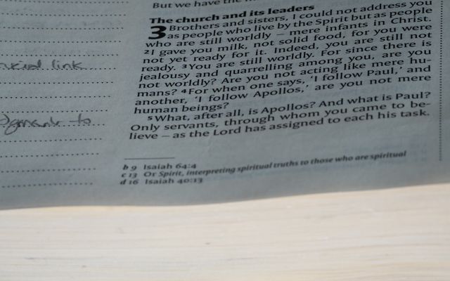 A close up of a newspaper with a clock on it
