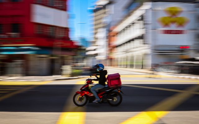 man in red jacket riding motorcycle on road during daytime