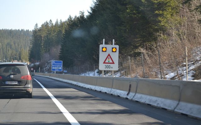 Warning sign with flashing lights on highway