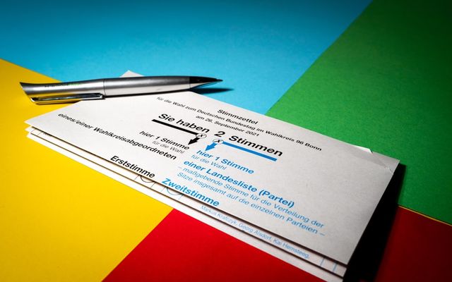 a close up of a pair of business cards and a pen