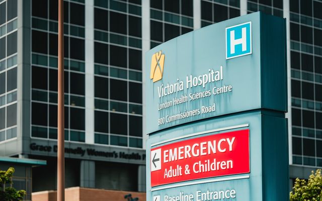 Victoria hospital emergency entrance sign with building