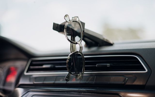 a car dashboard with a cell phone holder attached to it