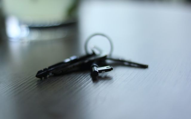 a pair of scissors sitting on top of a wooden table