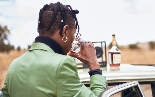 A woman sitting in a car talking on a cell phone