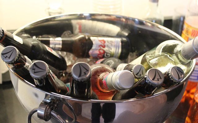 a metal bucket filled with lots of bottles
