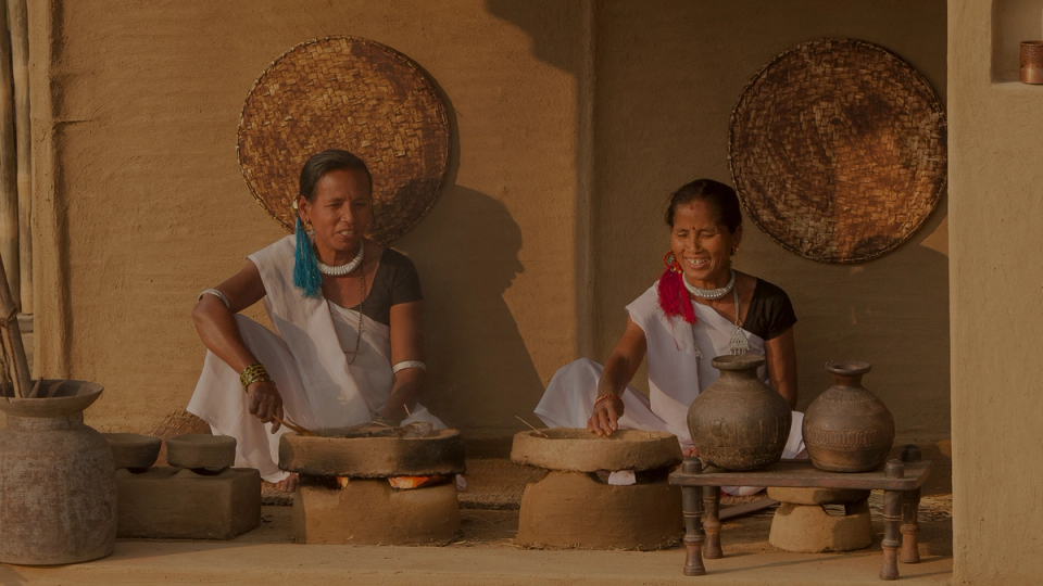 Women using eco-friendly cooking methods illustrating sustainability and community focus