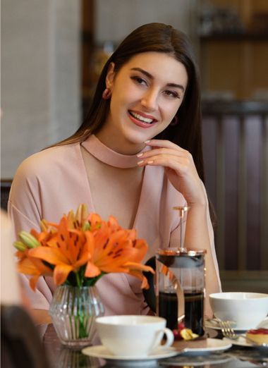 Friends chatting over coffee at restaurant table