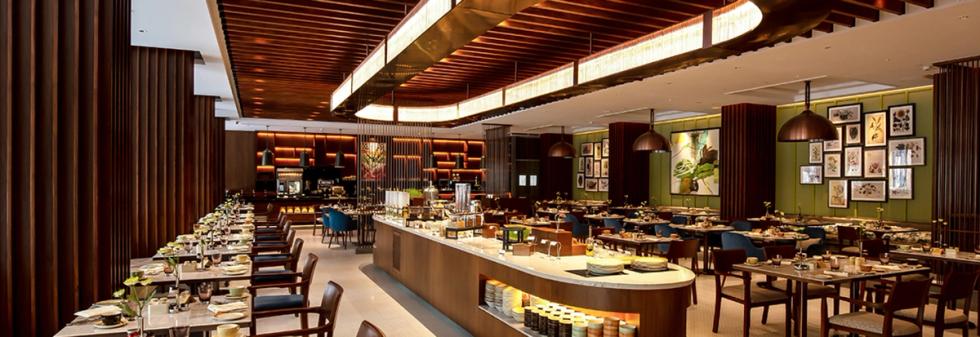 Luxury hotel restaurant interior with buffet counters and dining tables