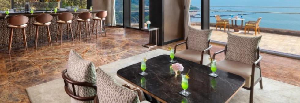 Luxury hotel lounge with ocean view and cocktail table seating