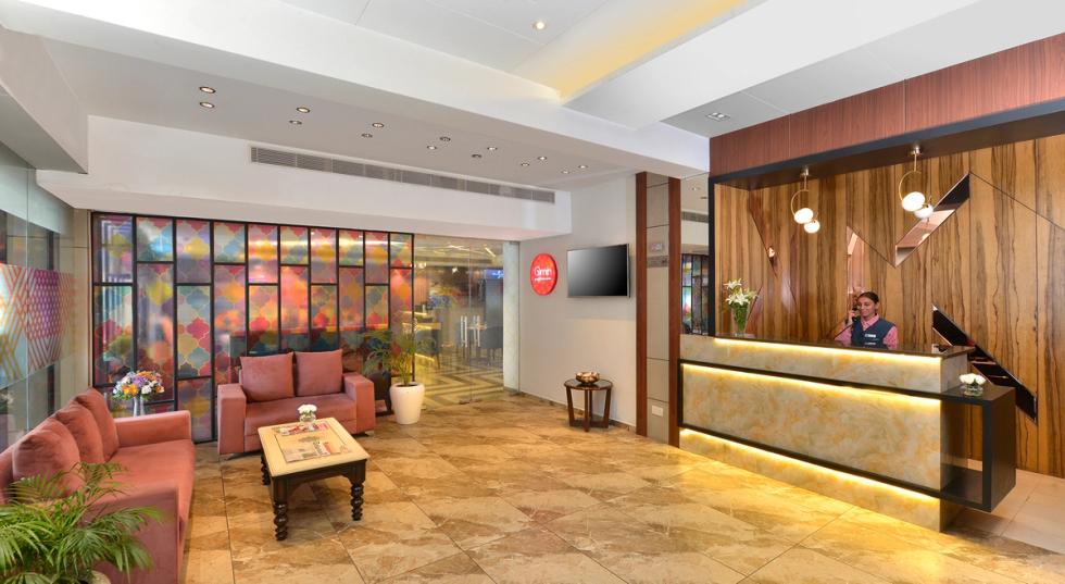 Bright and contemporary hotel reception area and lobby lounge at Ginger Hotel in Jammu.