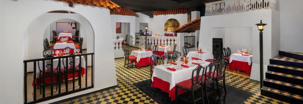 Vintage restaurant interior with white plaster walls and red table linens