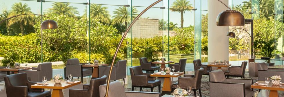 Luxury restaurant seating with glass walls and garden views