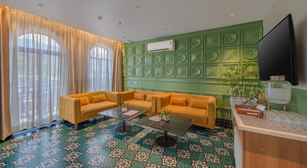 Lounge area at a hotel near Triveni Ghat, Rishikesh with comfortable seating and contemporary interiors.