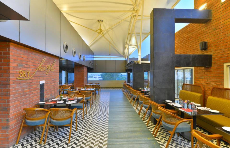 Sky High rooftop restaurant at Ginger Indore, Nipania with indoor dining and city views.