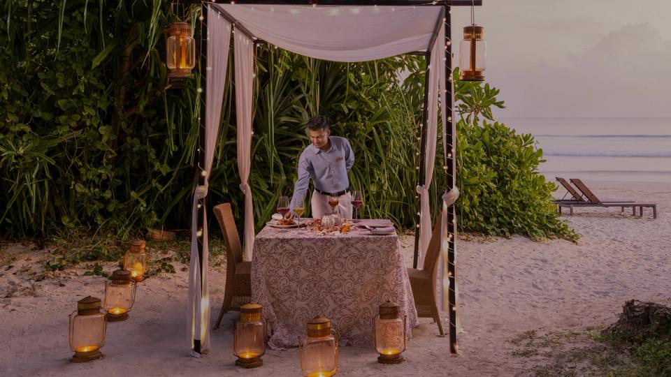 IHCL employee setting up a dining table for guests