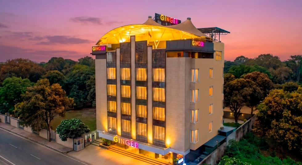 Exterior view of Ginger Indore, Nipania building surrounded by trees.