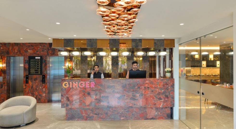 Reception desk with staff at the lobby of Ginger Indore, Nipania.