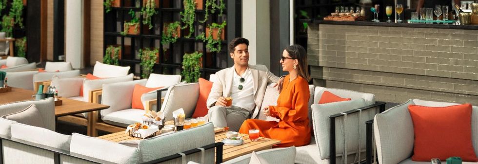 Guest enjoying drinks and snacks at a luxury restaurant