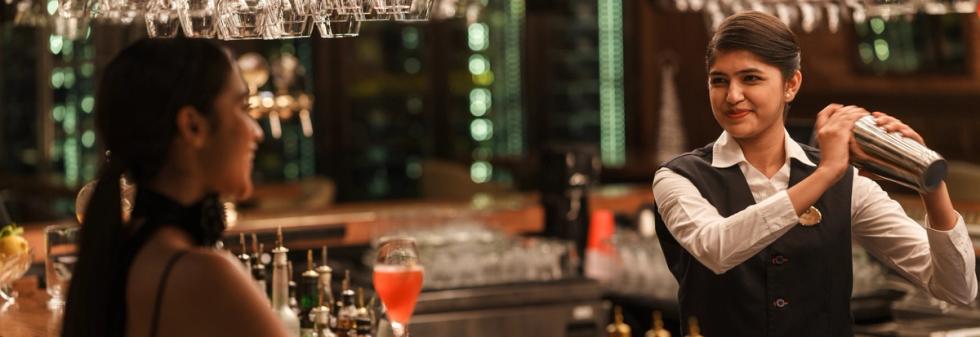 Bartender shaking a cocktail behind the bar