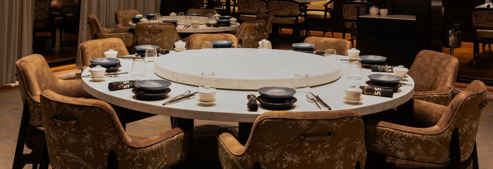 Circular dining table in dark, elegant restaurant interior