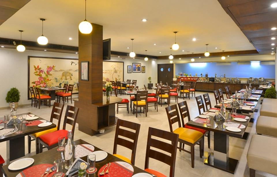 Restaurant seating at Qmin Bhavnagar, Kalubha Road.
