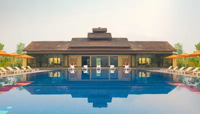 Sunlit pool deck with a tranquil ambiance - Meghauli Serai, Nepal