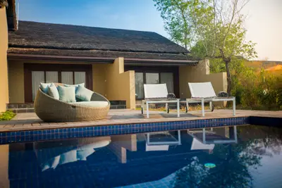 Inviting poolside oasis with lounge chairs - Meghauli Serai, Nepal