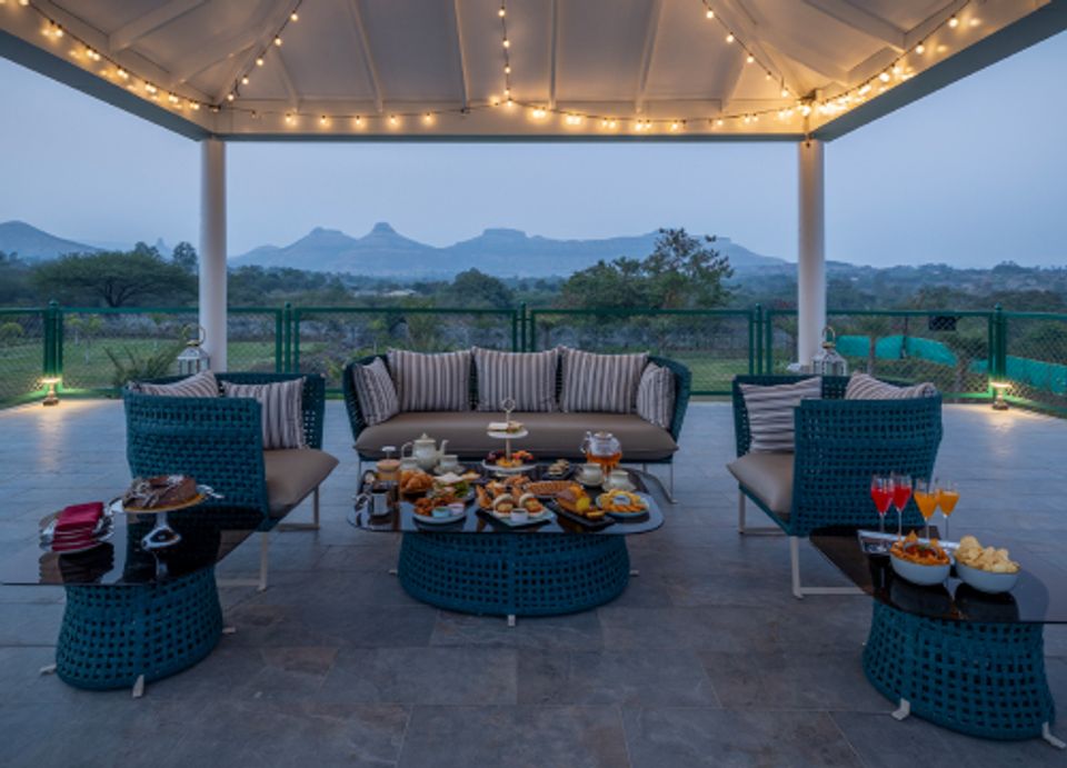 Outdoor lounge area at The Holland House, Nashik - amã Stays & Trails.