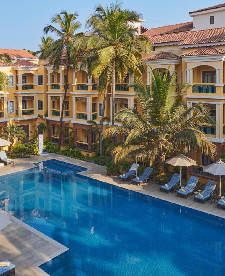 Pool with Relaxation chairs at La Estoria Goa - IHCL SeleQtions