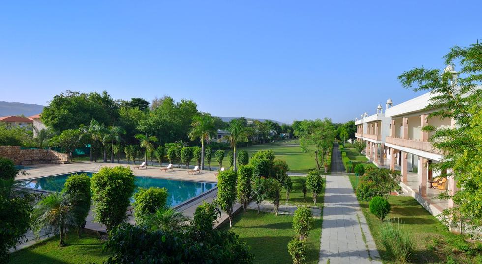 Exterior view of Ginger Ranthambore, Sawai Madhopur featuring the outdoor swimming pool and garden.