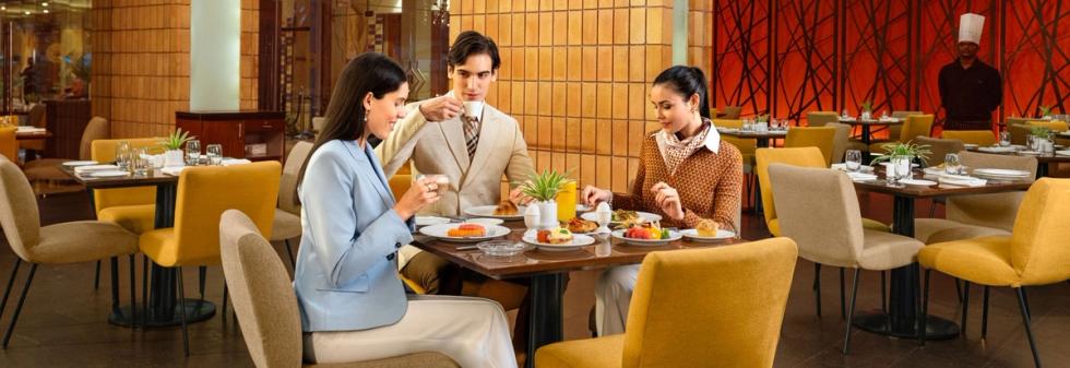Guests enjoying tea & snacks in restaurant in bangalore
