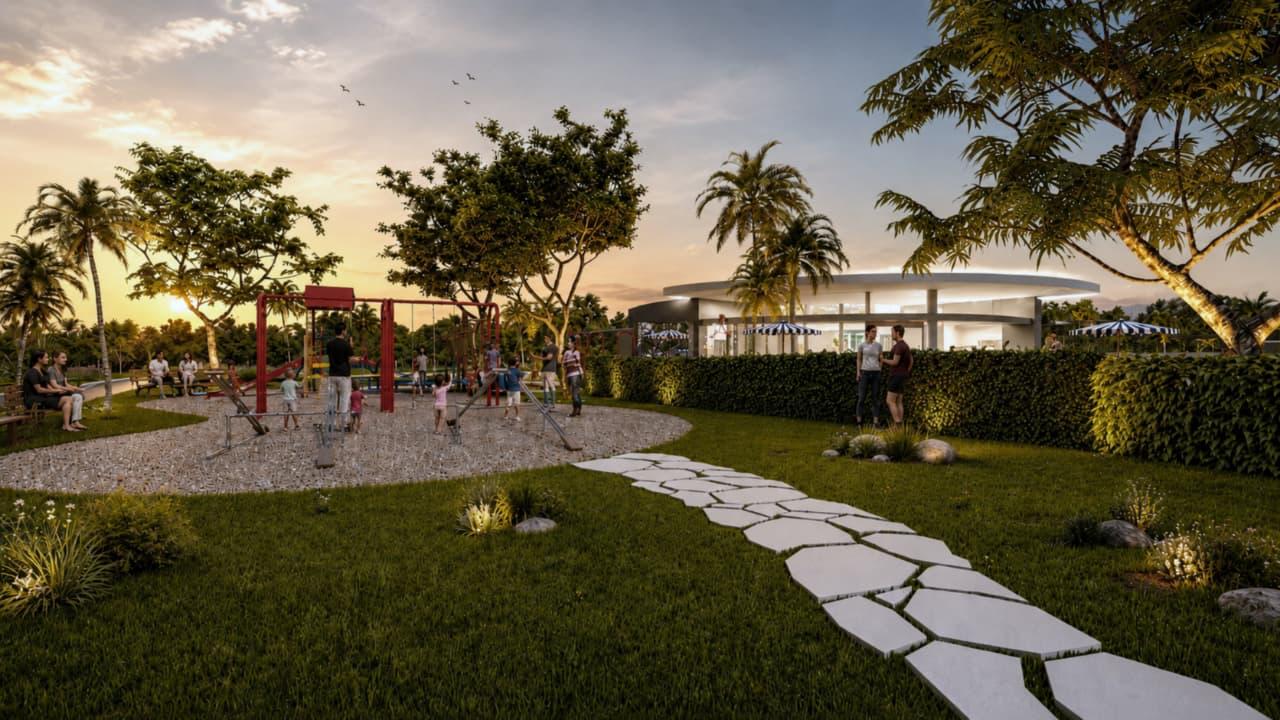 Parque infantil al atardecer, con la casa club al fondo