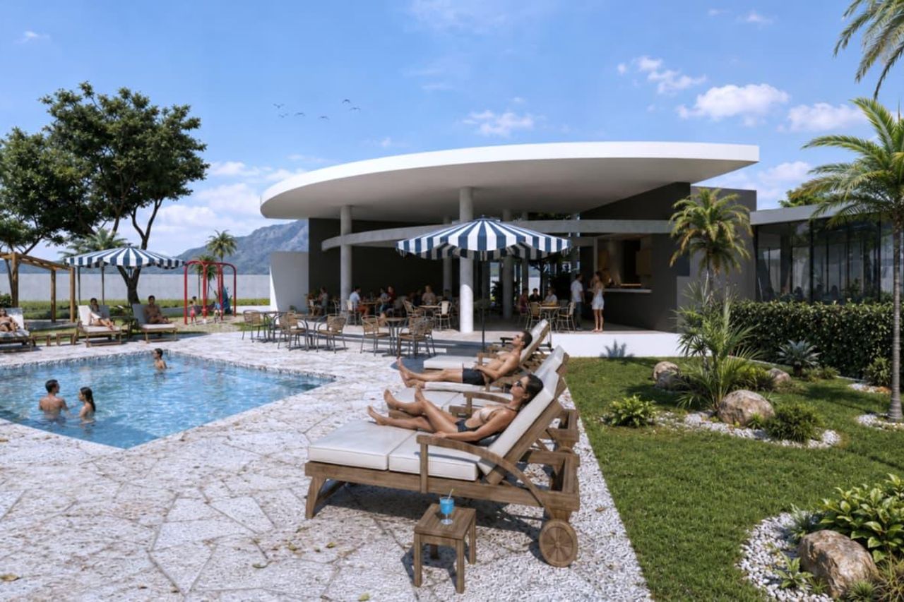 Área de camastros junto a la piscina y el jardín