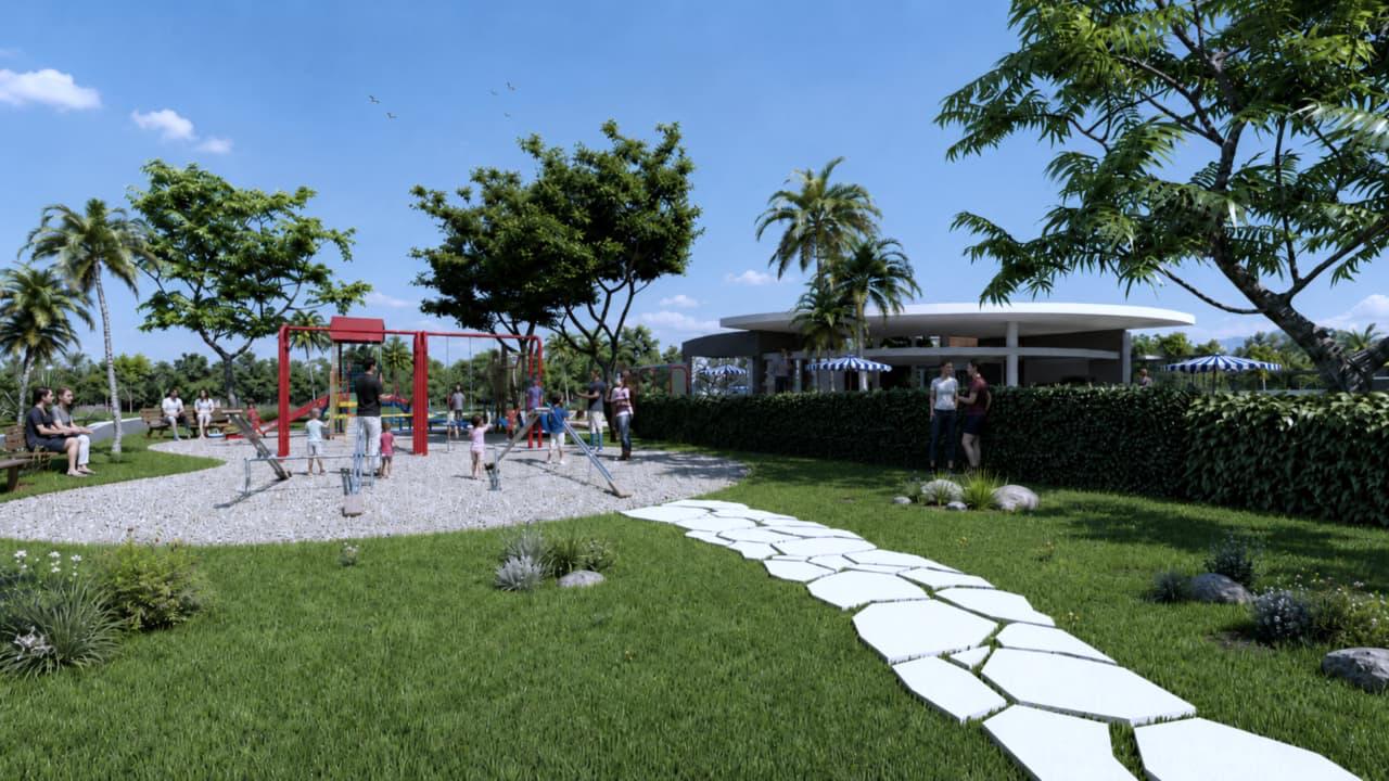 Camino entre áreas verdes hacia el parque infantil y la casa club