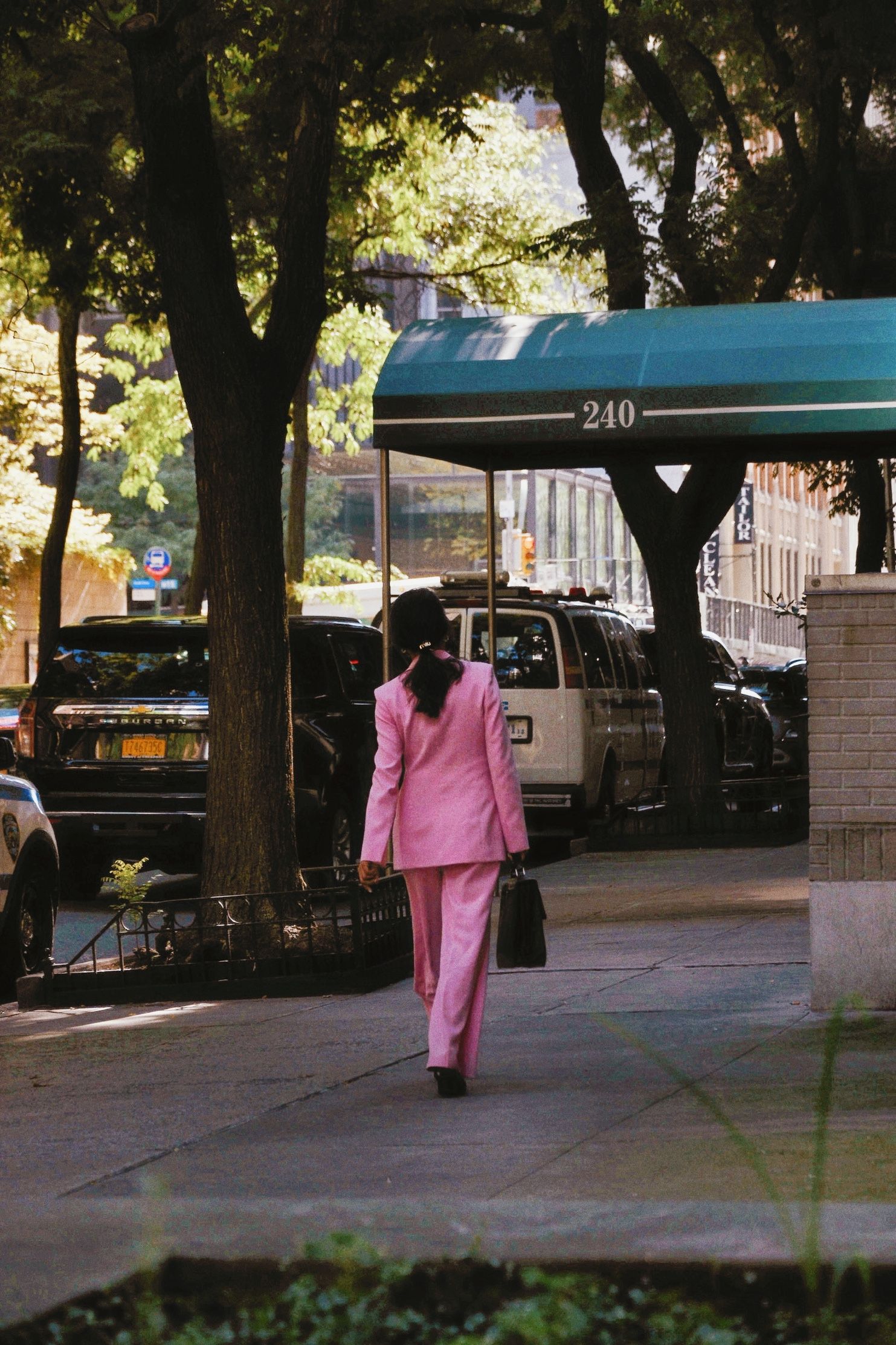 chic business person walking on sidewalk