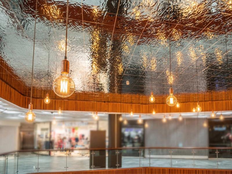 Młotkowany metalowy sufit z refleksami w centrum handlowym