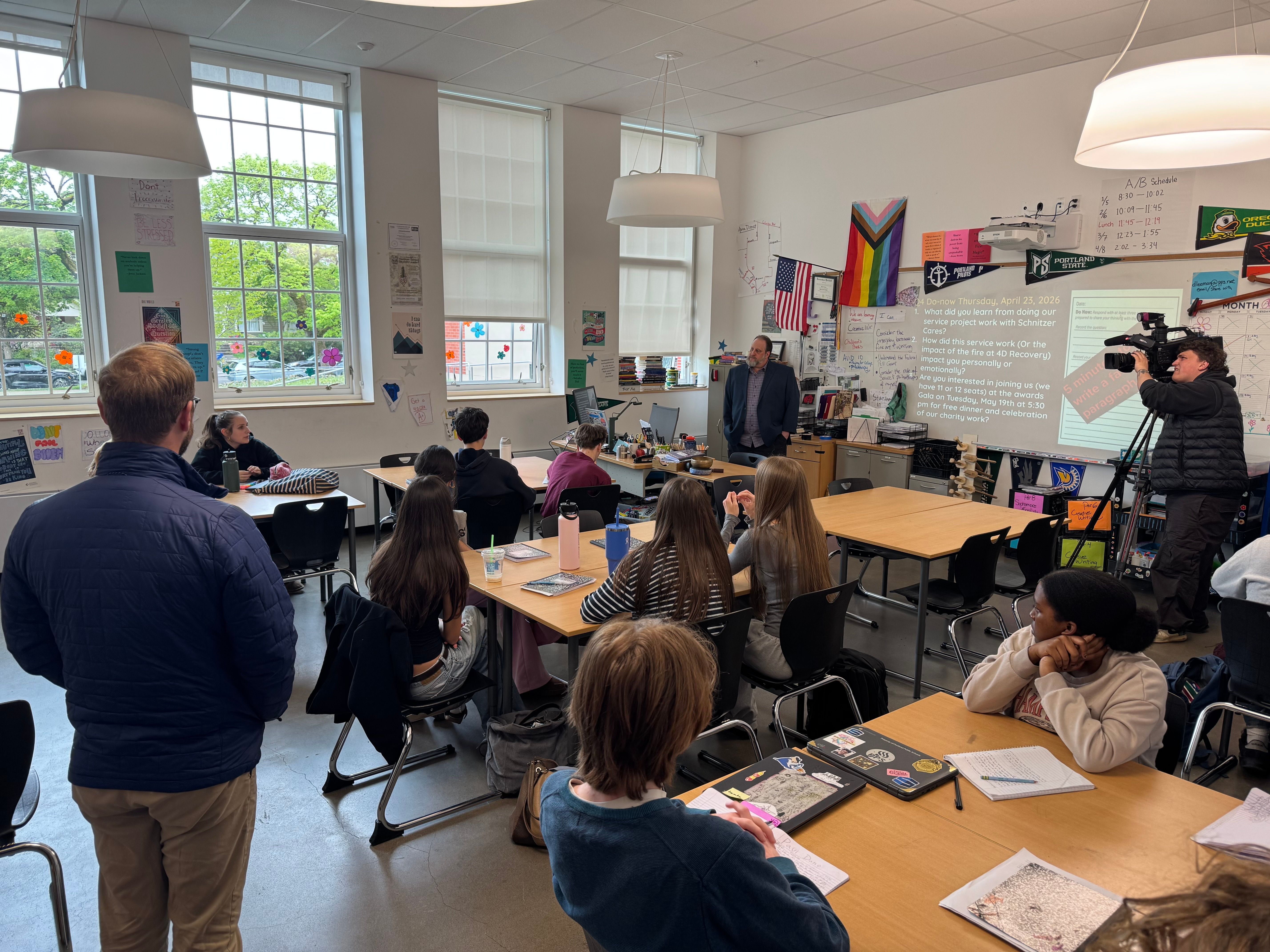 television news crew filming inside a high school classroom