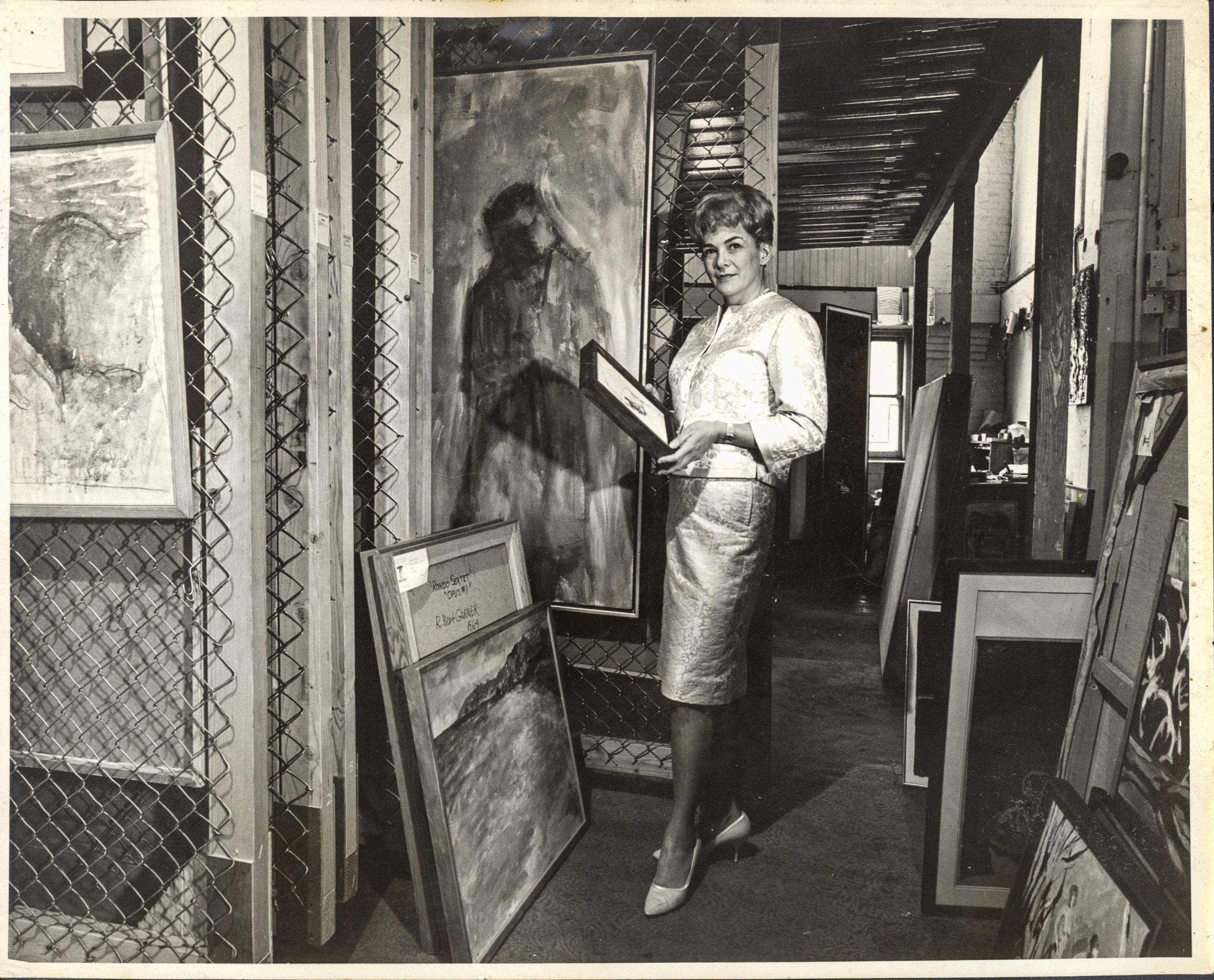 Arlene Schnitzer, gallerist and philanthropist, holding paintings