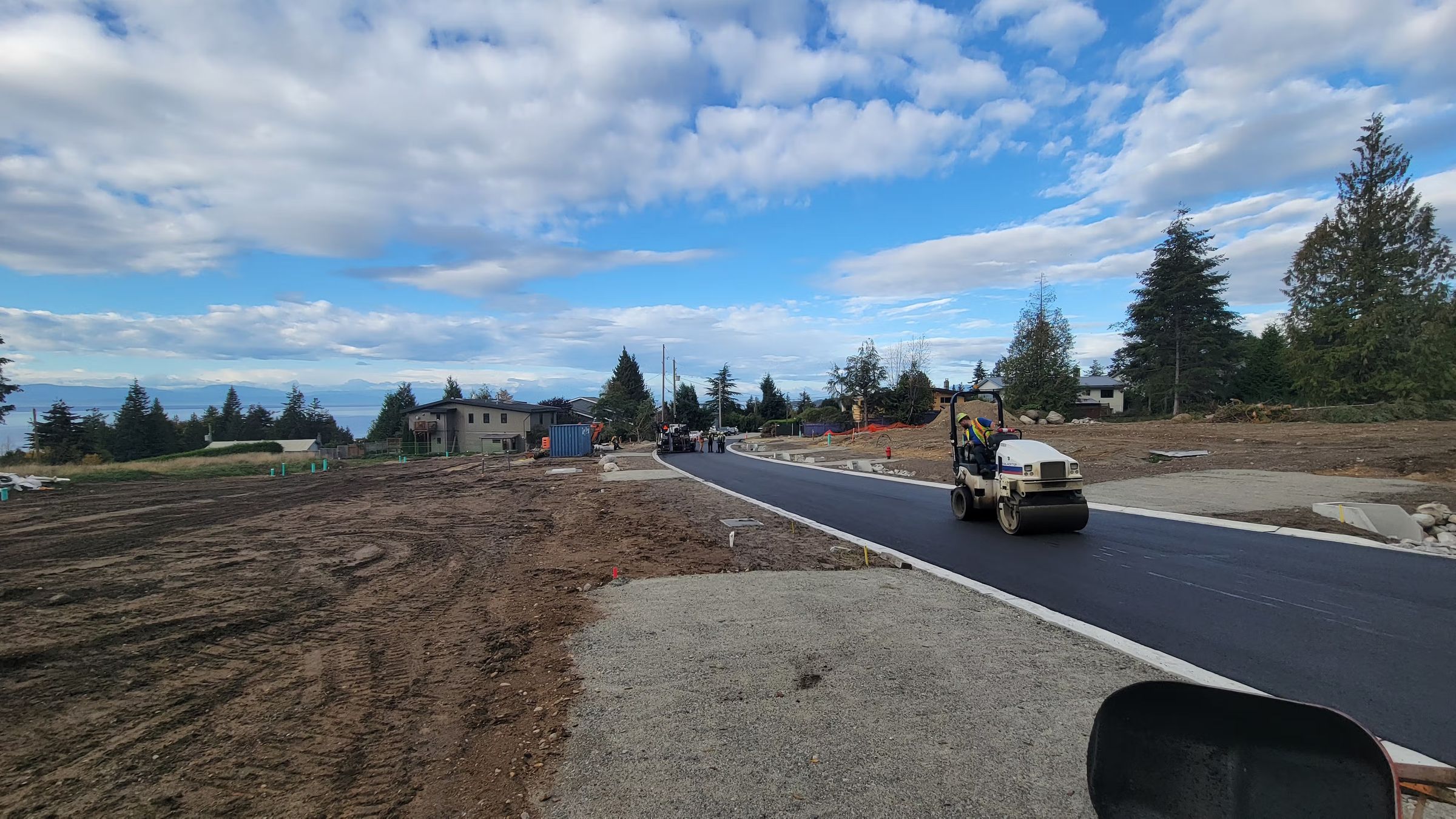 A new subdivision road being paved, with curb and lots on either side