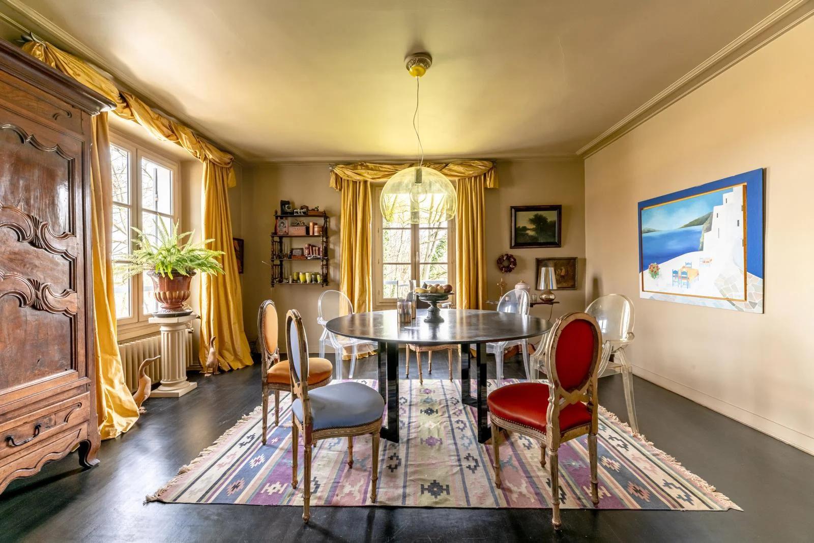 Salle à manger avec table ronde et fenêtres sur le jardin — Bougival.