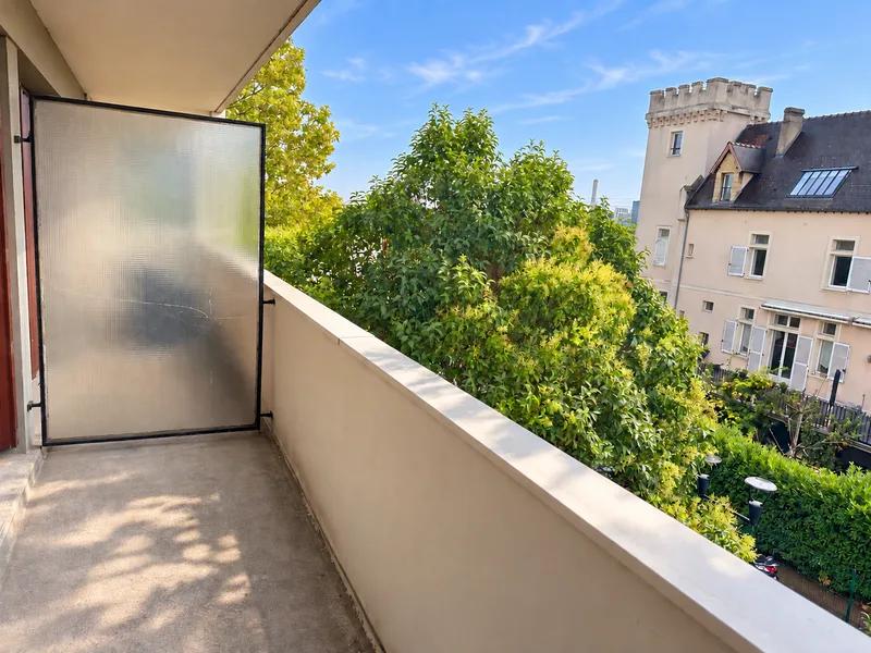 Balcon avec séparation vitrée et vue sur les arbres et les bâtiments voisins — Carrières-sur-Seine.