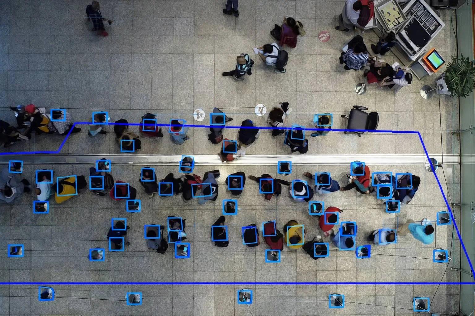 Overhead view of people waiting in structured lines utilizing AI video analytics for queue management, crowd counting, and wait time optimization.